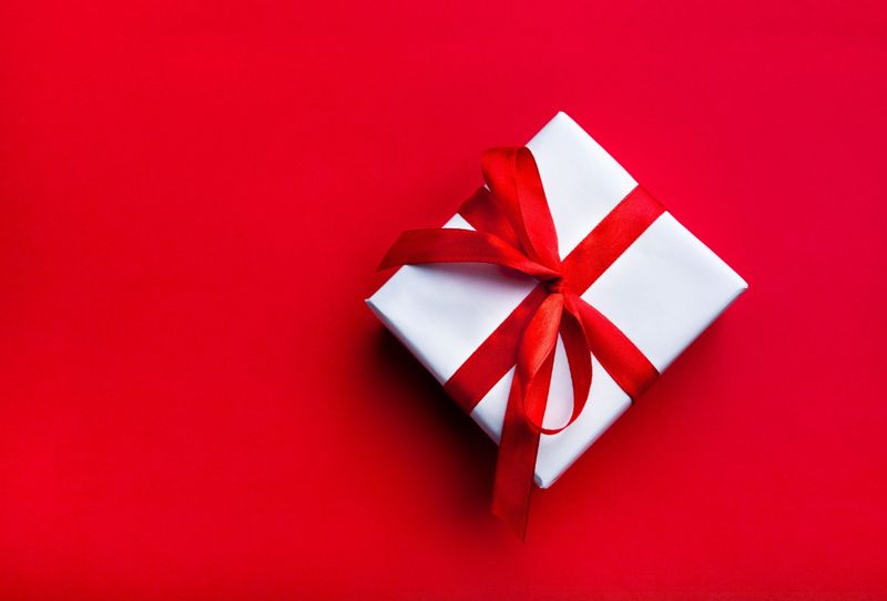 gift with red bow on red background